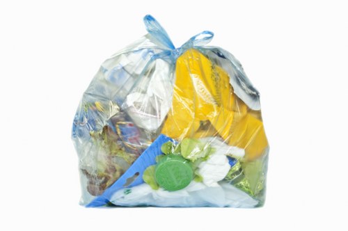 Electric low-emission van parked outside a business collecting recyclables