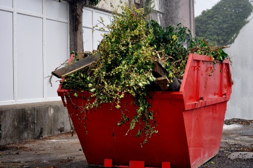 Workers securing loads on a waste removal vehicle and checking equipment